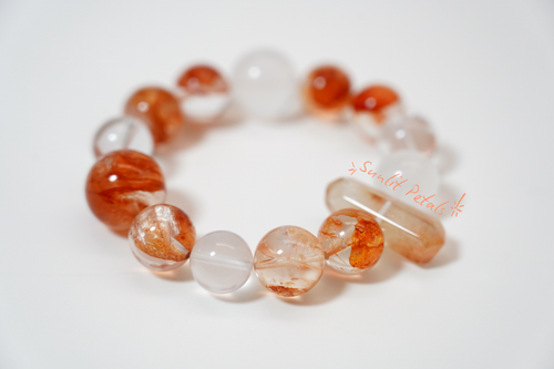 Amber Dawn Crystal Bracelet with orange and clear beads on a white background