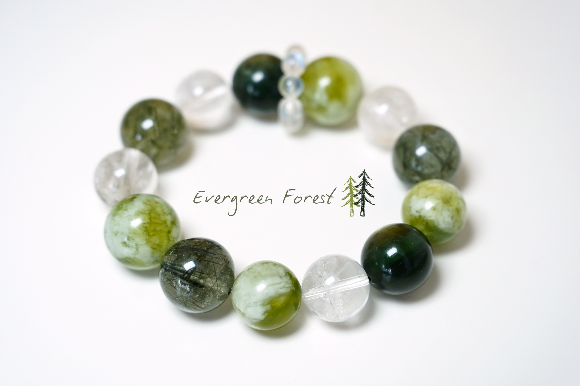 Glowing bracelet with green and clear beads on a white background, branded 'Evergreen Forest'.