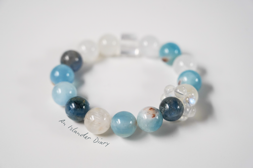 Beaded crystal bracelet with blue and white beads on a light background