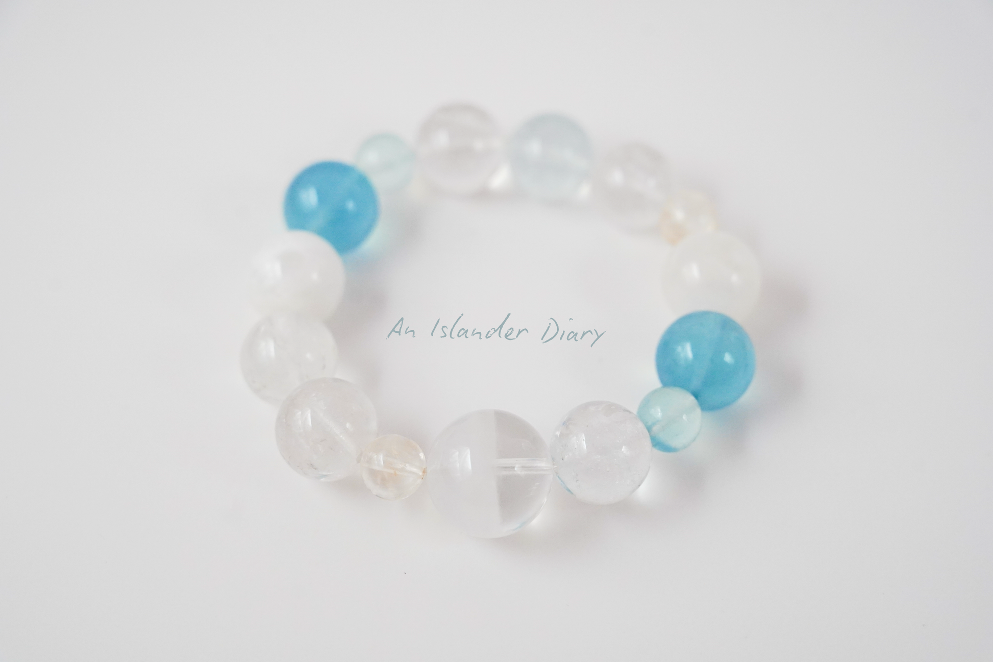 Beaded bracelet with blue and clear beads on a white background