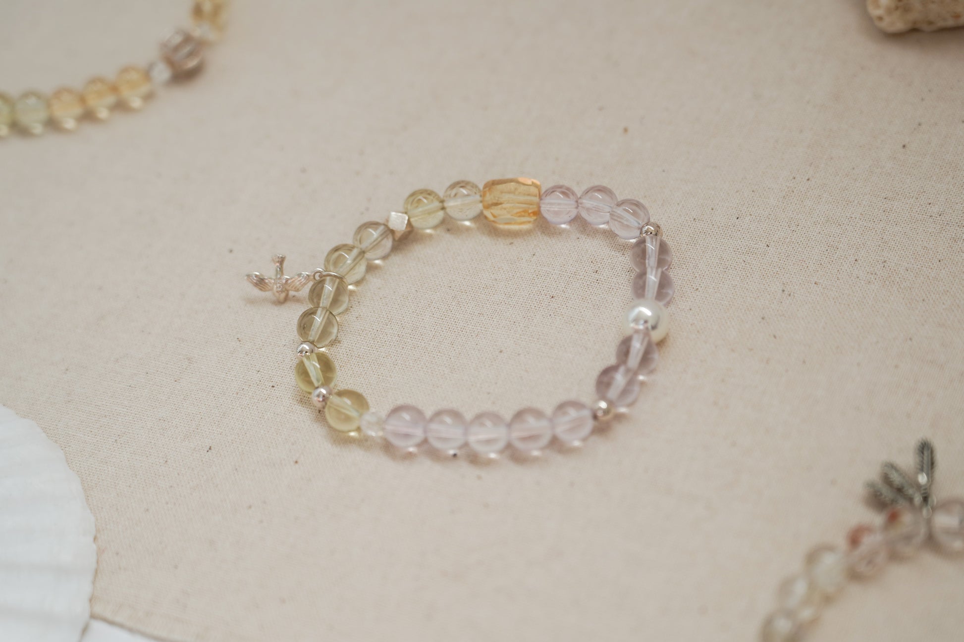 Beaded crystal bracelet with multicolored beads on a beige surface