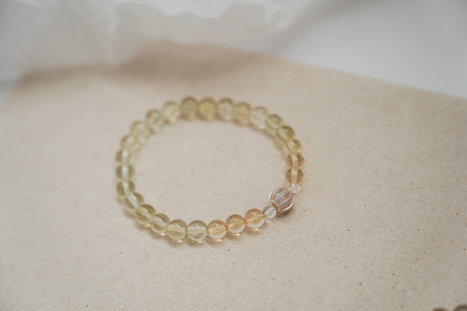 Beaded crystal bracelet on a textured fabric surface