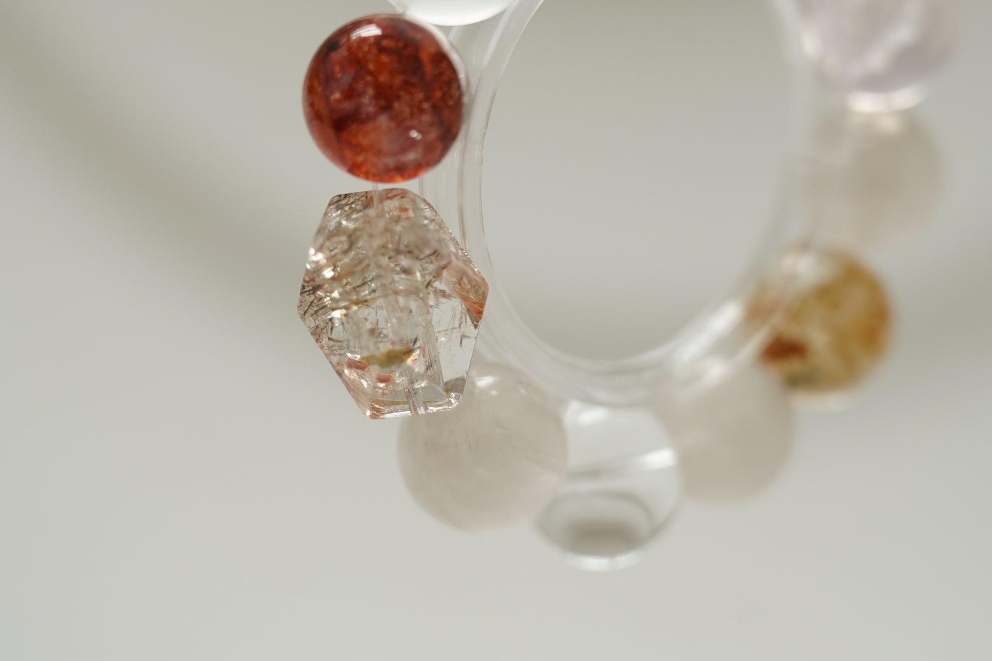 Close-up of a crystal bracelet with multicolored beads on a light background